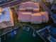 Aerial view of multi-unit buildings with a boat dock, adjacent to Intracoastal Waterway near beach and restaurants at 11595 Gulf Blvd # 6, Treasure Island, FL 33706
