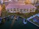 Stunning aerial view of a waterfront condo community with private docks and boat lifts at 11595 Gulf Blvd # 106, Treasure Island, FL 33706