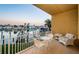 Outdoor balcony with seating area boasting waterfront views of the canal and surrounding community at 11595 Gulf Blvd # 6, Treasure Island, FL 33706
