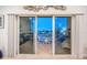Spacious waterfront balcony with outdoor seating accessible through sliding glass doors from the living area at 11595 Gulf Blvd # 6, Treasure Island, FL 33706