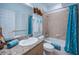 Bathroom featuring tiled shower/tub combo with blue accents and granite topped vanity and sink at 11595 Gulf Blvd # 6, Treasure Island, FL 33706