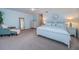 Spacious bedroom featuring light blue walls, soft carpet, and a comfortable chair at 11595 Gulf Blvd # 6, Treasure Island, FL 33706