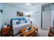 Bedroom featuring a cozy daybed adorned with colorful pillows, side table, and closet, creating a comfortable space at 11595 Gulf Blvd # 6, Treasure Island, FL 33706
