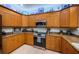 Kitchen featuring light wood cabinets, granite countertops, and stainless steel appliances, including a range and microwave at 11595 Gulf Blvd # 6, Treasure Island, FL 33706