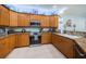 Fully equipped kitchen boasts light wood cabinets, granite countertops, and modern stainless steel appliances at 11595 Gulf Blvd # 6, Treasure Island, FL 33706