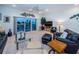 Cozy living room with a ceiling fan, modern decor, and a sliding glass door with a waterfront view at 11595 Gulf Blvd # 6, Treasure Island, FL 33706