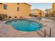 Community pool with brick patio, providing a refreshing oasis for relaxation and recreation at 11595 Gulf Blvd # 6, Treasure Island, FL 33706