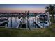 Waterfront view showing a boat lift and scenic canals with homes in the background at 11595 Gulf Blvd # 6, Treasure Island, FL 33706
