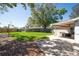 Large, grassy back yard with patio area at 11980 Valencia Ct, Seminole, FL 33772