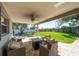 Spacious covered brick patio and manicured backyard at 11980 Valencia Ct, Seminole, FL 33772