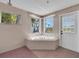 Bathroom featuring a white jacuzzi tub and shower at 11980 Valencia Ct, Seminole, FL 33772