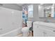 Clean bathroom with a shower-tub combo, gray walls, a white toilet, and a white vanity with a sink at 11980 Valencia Ct, Seminole, FL 33772