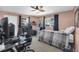 Comfortable bedroom featuring a bed, desk and computer, windows, and a mini-refrigerator at 11980 Valencia Ct, Seminole, FL 33772