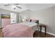Cozy bedroom with hardwood floors, a ceiling fan, and a pink dresser at 11980 Valencia Ct, Seminole, FL 33772