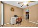 Functional home office with wood floors, a desk, chair, a ceiling fan, and access to storage space at 11980 Valencia Ct, Seminole, FL 33772