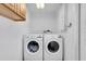 Bright laundry room features a washer and dryer and overhead storage cabinets at 11980 Valencia Ct, Seminole, FL 33772