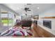 Spacious living room features a fireplace, ceiling fan, and sliding doors to outdoor space at 11980 Valencia Ct, Seminole, FL 33772