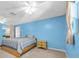 Main bedroom featuring blue walls, ceiling fans, neutral carpeting and bedroom dresser at 11980 Valencia Ct, Seminole, FL 33772