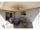 Covered patio with ceiling fan, patio furniture and brick pavers at 11980 Valencia Ct, Seminole, FL 33772