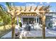 Back patio with casual seating, grill and pergola perfect for outdoor entertaining at 1269 80Th N Ave, St Petersburg, FL 33702