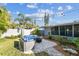 Landscaped backyard featuring a fire pit, seating, and mature trees for a serene outdoor setting at 1269 80Th N Ave, St Petersburg, FL 33702