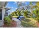 Grassy backyard featuring a patio with seating, landscaping, and trees for a private outdoor space at 1269 80Th N Ave, St Petersburg, FL 33702