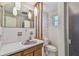Bathroom with unique wooden columns, decorative wallpaper, and a shower at 1269 80Th N Ave, St Petersburg, FL 33702