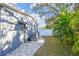 Exterior view of the home showcasing the brick-paved walkway and well-maintained landscaping at 1269 80Th N Ave, St Petersburg, FL 33702