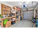 Garage has a pegboard wall, work bench and a large grey garage door at 1269 80Th N Ave, St Petersburg, FL 33702