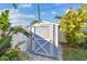 Backyard utility shed with a double door, situated on a paved area with nearby greenery at 1269 80Th N Ave, St Petersburg, FL 33702