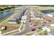 Aerial image showcasing completed new construction homes and community layout along a main road and pond at 13162 Goldstone Ct, Wimauma, FL 33598