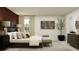 The main bedroom with a stylish upholstered headboard, bench, and coordinating artwork at 13162 Goldstone Ct, Wimauma, FL 33598