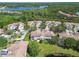 Peaceful aerial view of townhomes, offering a blend of natural beauty with lush greenery and a serene community lake at 14542 Mirabelle Vista Cir, Tampa, FL 33626