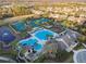 Aerial view of the community pool, pond, clubhouse, and tennis courts at 14542 Mirabelle Vista Cir, Tampa, FL 33626