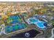 Aerial view of community featuring a swimming pool, tennis courts, and pond at 14542 Mirabelle Vista Cir, Tampa, FL 33626