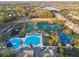 Community amenities, including a pool, tennis courts, and a playground, are highlighted in this aerial view of the townhomes at 14542 Mirabelle Vista Cir, Tampa, FL 33626