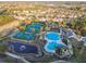 Aerial view of the community pool, tennis courts, and surrounding homes in a lushly landscaped neighborhood at 14542 Mirabelle Vista Cir, Tampa, FL 33626