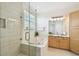 Spa-like bathroom featuring a glass enclosed shower, soaking tub, and vanity at 14542 Mirabelle Vista Cir, Tampa, FL 33626