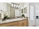 Well-lit bathroom with granite countertop, large mirror, and tiled shower at 14542 Mirabelle Vista Cir, Tampa, FL 33626