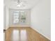 Bright bedroom featuring wood-look floors, neutral walls, ceiling fan, and windows at 14542 Mirabelle Vista Cir, Tampa, FL 33626
