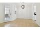 Open dining area featuring tile floors, a modern light fixture, and a door to the patio at 14542 Mirabelle Vista Cir, Tampa, FL 33626
