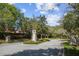 Stone sign marking the entrance of the community surrounded by mature trees and landscaping at 14542 Mirabelle Vista Cir, Tampa, FL 33626