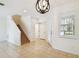 Bright entryway with tile floors, staircase, and stylish chandelier at 14542 Mirabelle Vista Cir, Tampa, FL 33626