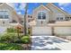 Charming townhome with an attached garage, stone accents, and well-maintained landscaping at 14542 Mirabelle Vista Cir, Tampa, FL 33626