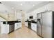 Bright kitchen featuring stainless steel appliances, white cabinetry, and granite countertops at 14542 Mirabelle Vista Cir, Tampa, FL 33626