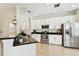 Well-appointed kitchen with stainless steel appliances, white cabinetry, and dark countertops at 14542 Mirabelle Vista Cir, Tampa, FL 33626