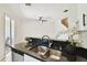 Kitchen island featuring sink, stainless steel dishwasher, and view into dining area at 14542 Mirabelle Vista Cir, Tampa, FL 33626