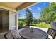 Outdoor patio with dining set overlooking a beautifully landscaped backyard at 14542 Mirabelle Vista Cir, Tampa, FL 33626