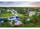Aerial view of the property featuring a pool, lush greenery and neighborhood views at 15099 Community Ave, Port Charlotte, FL 33953