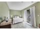 Relaxing bedroom featuring a sliding glass door, natural light, and a comfortable queen-sized bed at 15099 Community Ave, Port Charlotte, FL 33953